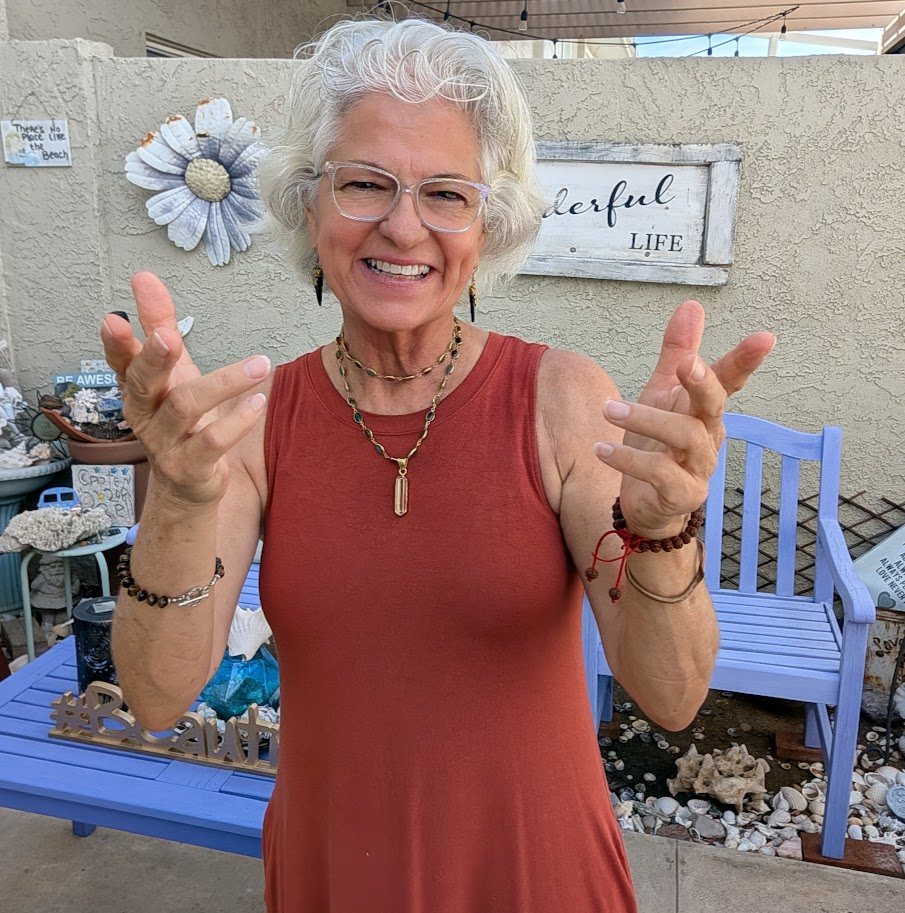 Angel Marie Monachelli smiling with open hands