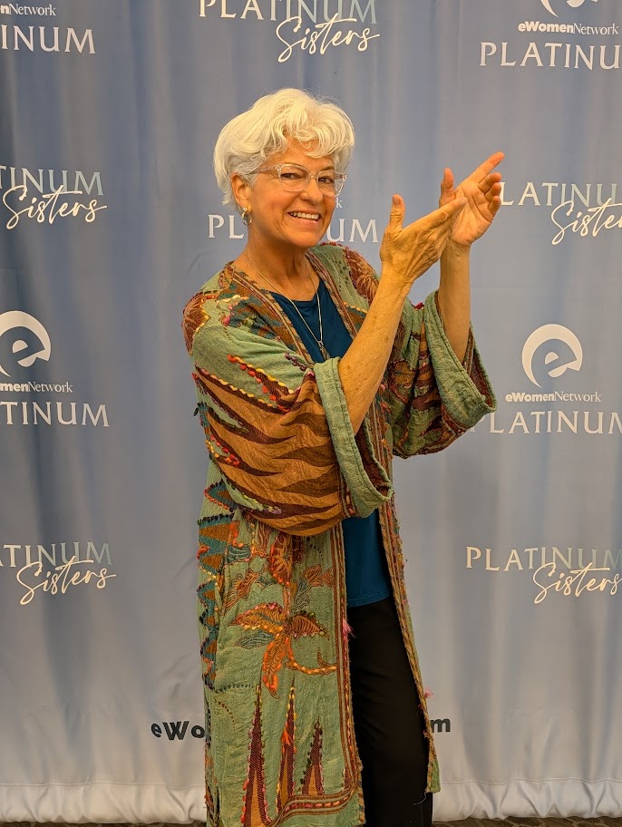 Angel Marie Monachelli at a media event step-and-repeat